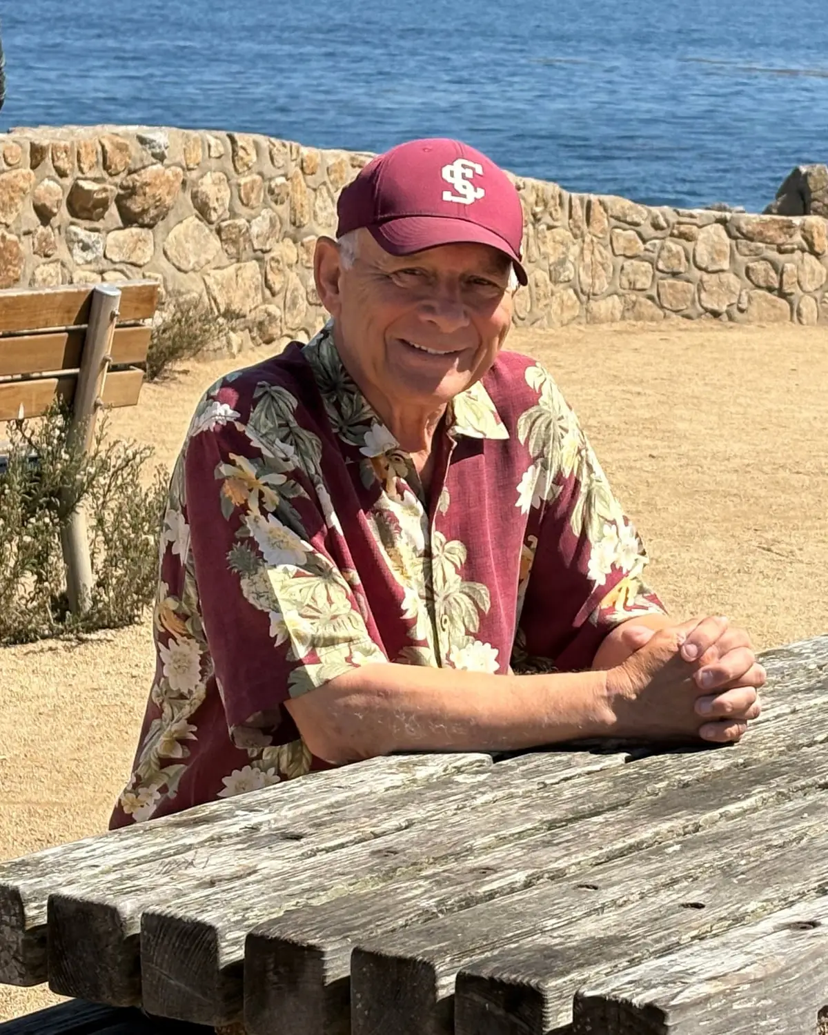 Andrew Kubica sitting at a picnic table above the water at Lovers Point in Pacific Grove.